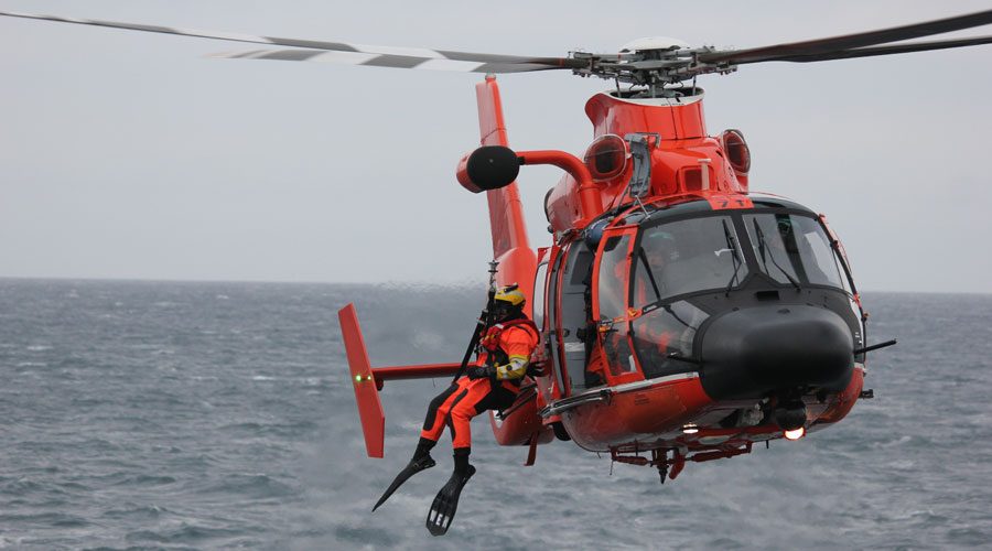 Air Rescue Helicopter with a Survival Swimmer Hanging Out Preparing for Mission